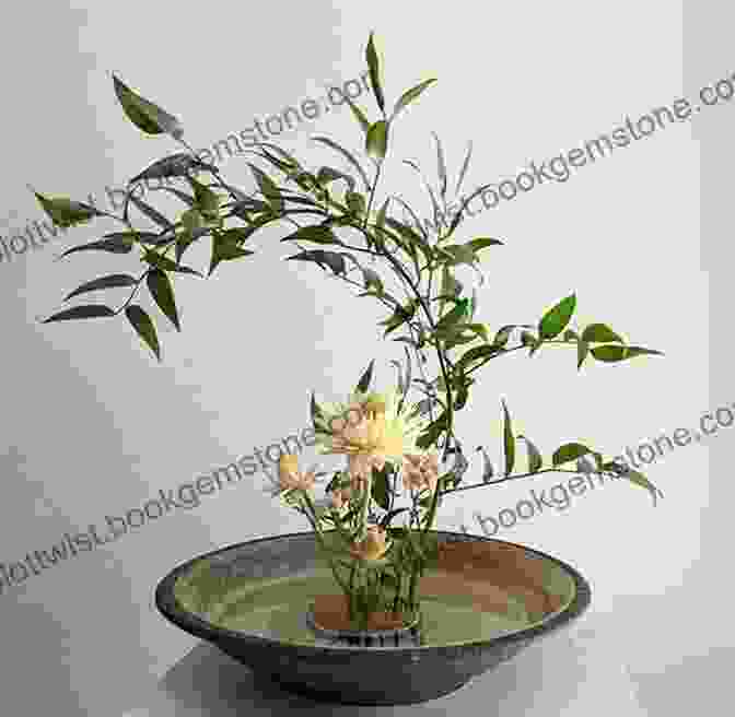 A Traditional Japanese Ikebana Arrangement With Simple Flowers And Leaves In A Minimalist Vase Be More Japan: The Art Of Japanese Living